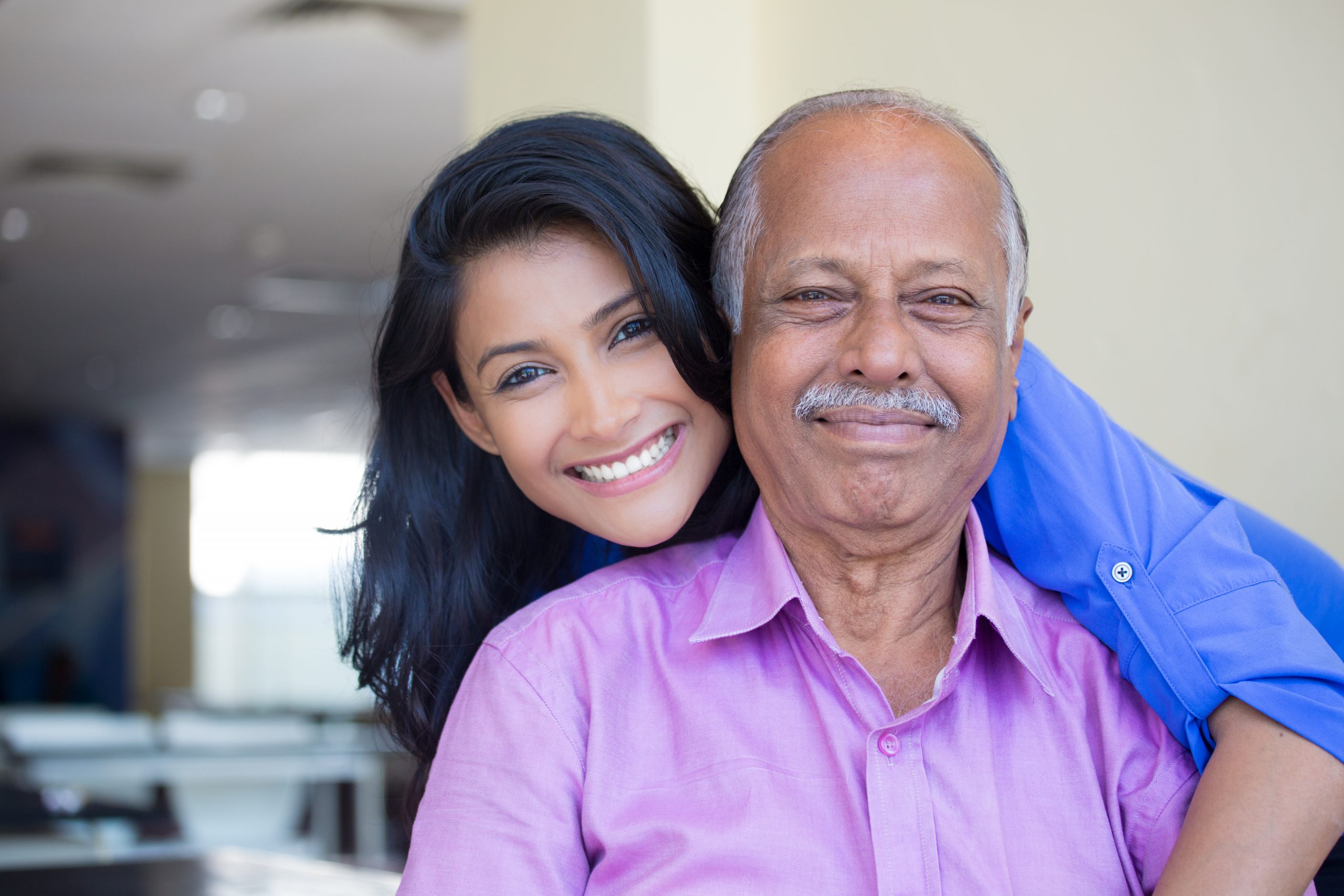 Caregiver and senior smiling together
