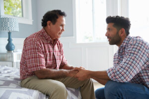 A senior man and his son talking about transitioning to the memory care in San Juan Capistrano