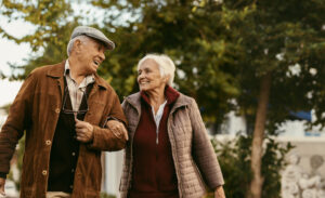 A happy senior couple goes for a walk outdoors