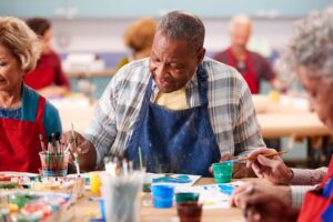 A group of seniors working on an art project at their Alzheimer's and dementia community