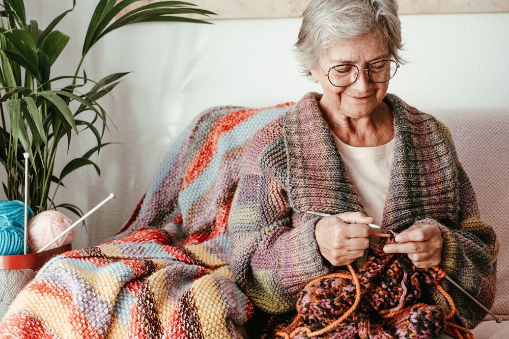 A senior worman knitting